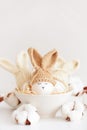 Easter eggs in crochet knitted hats with rabbit ears in nest. Easter celebration concept Royalty Free Stock Photo