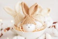 Easter eggs in crochet knitted hats with rabbit ears in nest. Easter celebration concept Royalty Free Stock Photo