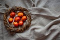 Easter Eggs Decorated with Natural Fresh Leaves and Boiled in Onions Peels on gray linen tablecloth in a wreath. Happy Easter conc Royalty Free Stock Photo