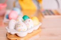 Easter eggs of different colors and in stickers in white tray on wooden table Royalty Free Stock Photo