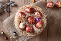 Easter eggs dyed with onion peels, with a pattern of fresh herbs, in a basket Royalty Free Stock Photo