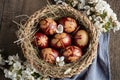 Easter eggs dyed with onion peels with a pattern of fresh herbs in a basket Royalty Free Stock Photo