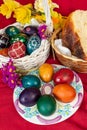 Easter eggs and Easter bun with flowers - red background