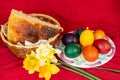 Easter eggs and Easter bun with flowers - red background