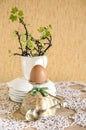 Easter eggs in eggcups with gold spoons Royalty Free Stock Photo