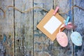 Easter eggs and empty photo frame hanging on craft ribbon Royalty Free Stock Photo