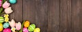 Easter eggs and flower decoration corner border against a dark rustic wood banner background Royalty Free Stock Photo