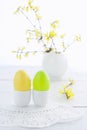 Easter eggs and flowering branches on wooden table