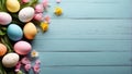 Easter eggs with flowers on blue wooden background, copy space