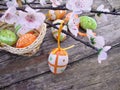 Easter eggs with flowers on wooden background