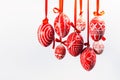 Easter eggs with folk Ukrainian pattern hang on red ribbons from right side on white background. Ukrainian traditional eggs Royalty Free Stock Photo