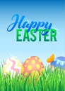 Easter eggs in Fresh Green Grass. Decorated Easter Eggs in Grass on Sky Background. Happy Easter Calligraphy Poster Royalty Free Stock Photo