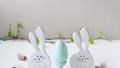 Easter eggs and funny bunnys on white table. Happy easter. Festive wooden decoration. Holiday concept, springtime. High quality 4k