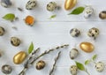 Easter. Easter eggs of gold and natural color with willow branches on a light background with space for text