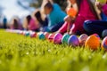 Easter eggs on grass with children in the background. Royalty Free Stock Photo