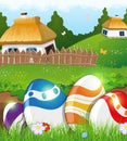 Easter eggs in the grass and rural houses