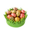 Easter eggs in green basket isolated over white