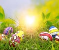 Easter eggs on green grass with bokeh background and sun ray Royalty Free Stock Photo