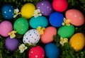 Easter eggs hand painted on green grass with flowers. Happy Easter