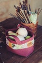 Easter eggs in handmade quilt bag on wooden table with decorations