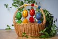 Hand painted Easter eggs, made of wood in a brown wicker basket Ã¢â¬â decoration of a holiday table during celebration