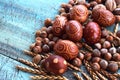 Easter eggs natural arrangement with hazelnuts, spelt, apricot kernels an walnuts