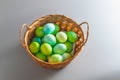 Easter eggs of natural dyes in harmony with nature in a wicker basket made of straw Royalty Free Stock Photo
