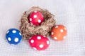 Easter eggs near birds nest on checkered white background Royalty Free Stock Photo