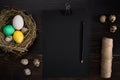Easter eggs in nest, scissors and thread on a black background Royalty Free Stock Photo