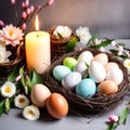 easter eggs in a nest with spring flowers and burning candle on grey background