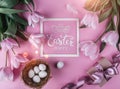 Easter eggs in nest and tulips flowers on pink background with Easter card. Waiting for spring. Top view with copy space Royalty Free Stock Photo