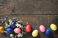 Easter eggs in a nest with willow branches and spring flowers Royalty Free Stock Photo