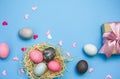 Easter eggs and nestle with eggs on blue background