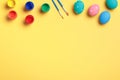 Easter eggs paint and brush on a yellow background Royalty Free Stock Photo