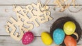 Easter eggs painted in pastel colors on the nest with text happy easte on white wooden background. Easter concept Royalty Free Stock Photo