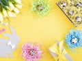 Easter eggs in a paper box and nests. Easter Bunny with a bow and spring flowers.. Royalty Free Stock Photo