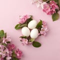 Easter eggs and pink flowers on white background. Easter nest. Flat lay, top view, concept of spring, femininity and beauty.