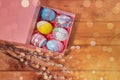 Easter eggs in a pink gift box on a wooden table Royalty Free Stock Photo