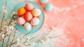 Easter eggs on a plate with spring flowers on pink background, top view, text space Royalty Free Stock Photo