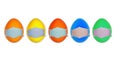 Easter eggs in a protective medicine mask on a white isolate. Easter quarantined concept with place for text. Stop VIRUS Royalty Free Stock Photo