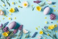 Easter eggs with purple and yellow flowers on pastel Spring blue background Royalty Free Stock Photo