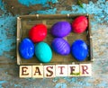 Easter eggs on rural blue moss background. wooden letters Royalty Free Stock Photo