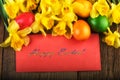 Easter eggs with spring flowers on old wood. Text Happy Easter Royalty Free Stock Photo