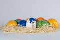 Easter eggs on straw being painted