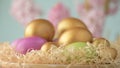 Easter eggs in straw spin on blue background