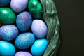 Easter eggs with a top view. Painted chicken eggs in blue, green and purple