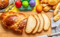 Easter eggs and tsoureki braid, greek easter sweet bread, on wood Royalty Free Stock Photo