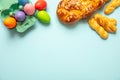 Easter eggs and tsoureki braid, greek easter sweet bread, on blue background Royalty Free Stock Photo