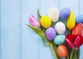 Easter eggs tulip flowers decorative on blue wooden festival pattern springtime Royalty Free Stock Photo