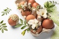 Easter eggs, twigs, flowers and lace ribbon on white background, closeup